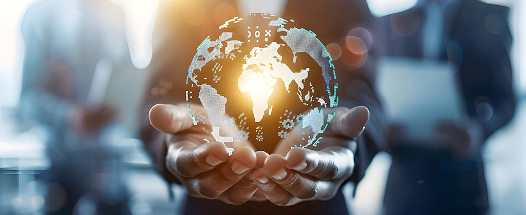 Hands of a professional holding a digital hologram of the Earth, symbolising global innovation and technology