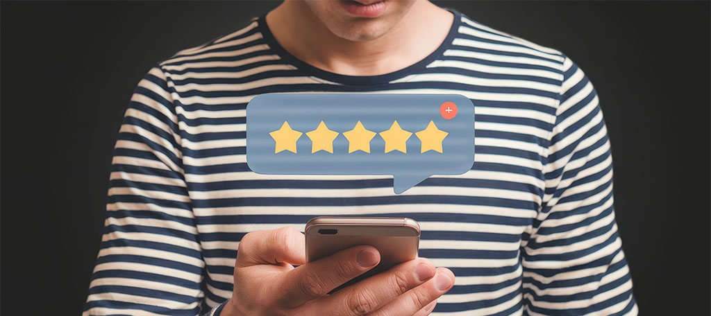 Person using a smartphone with a five-star rating overlay